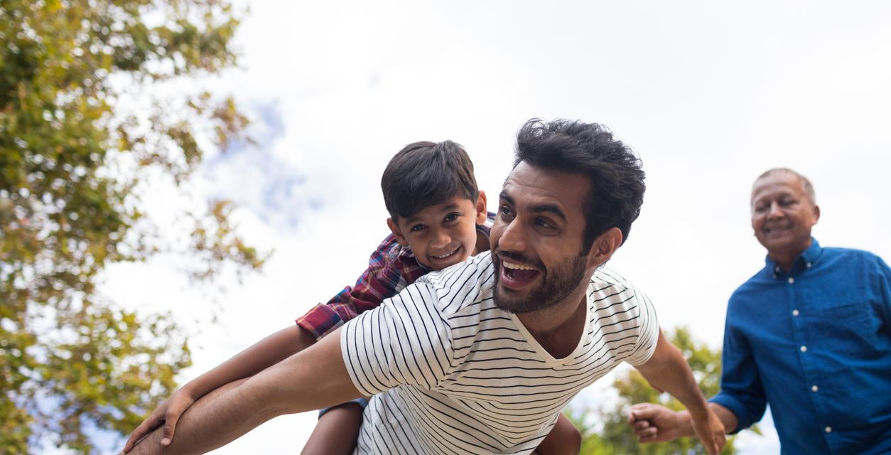 Dad carries son on his back