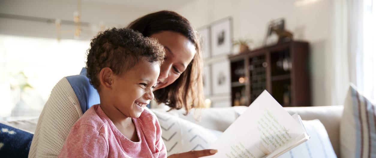 Mother reads book to child